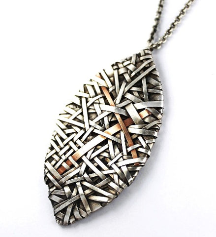 woven petal pendant handcrafted in silver with gold detail by jewellery designer Patricia Gurgel Segrillo